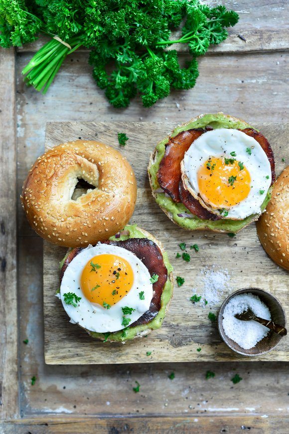 Bagels met krokante bacon, guacamole en een spiegeleitje